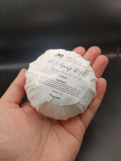 Hand Holding the solid dish soap refill to show proportion and size