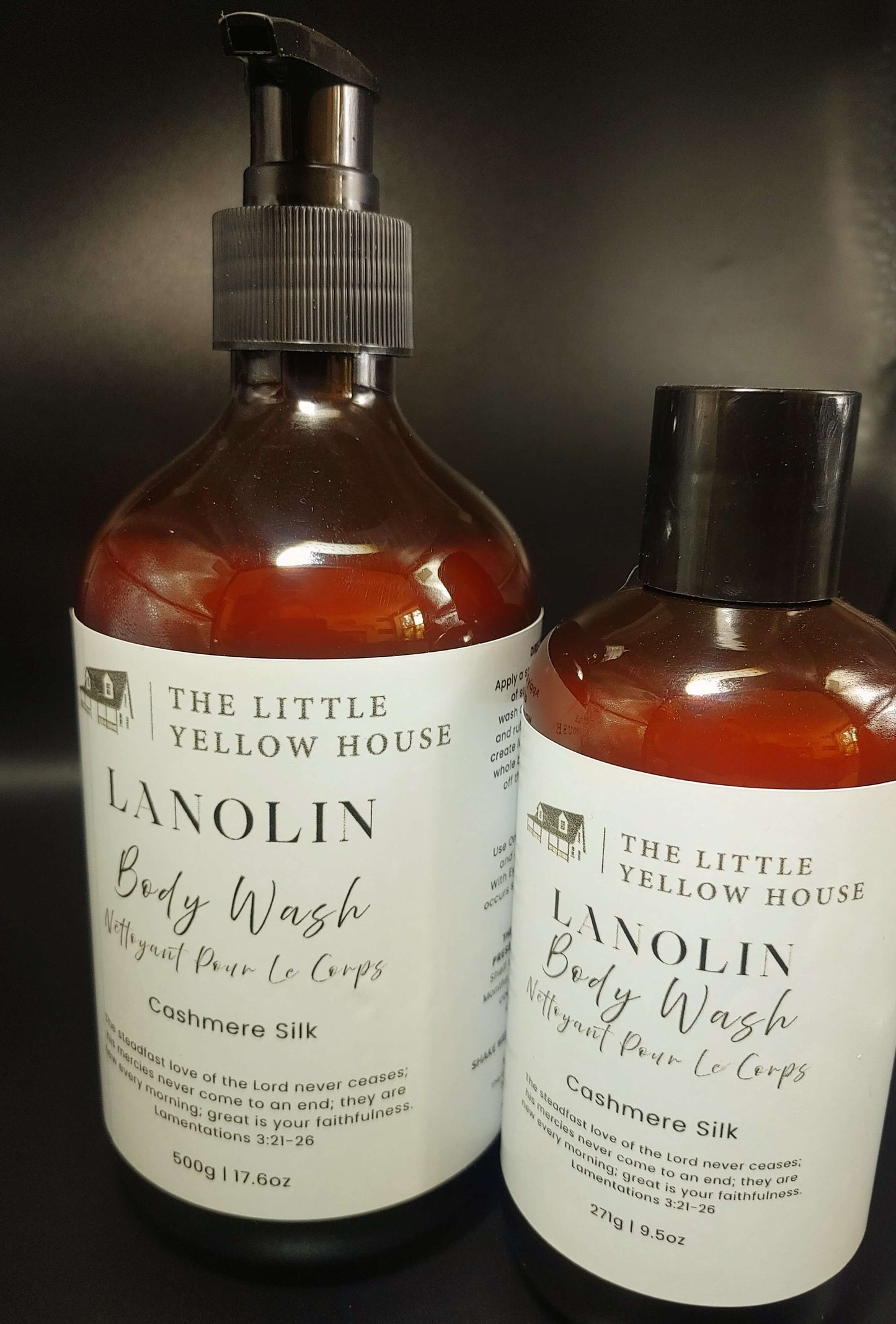 Two bottles of 'The Little Yellow House' Lanolin Body Wash on a dark background-Cashmere Silk